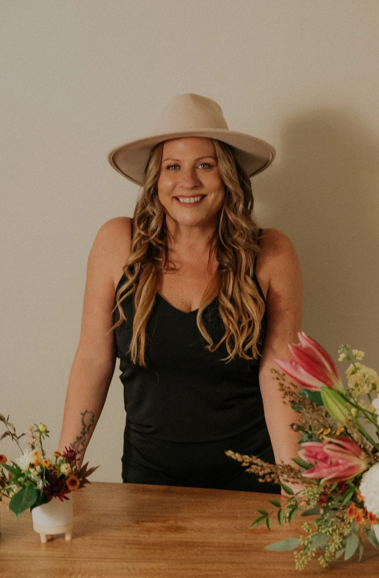 Smiling woman with floral arrangement