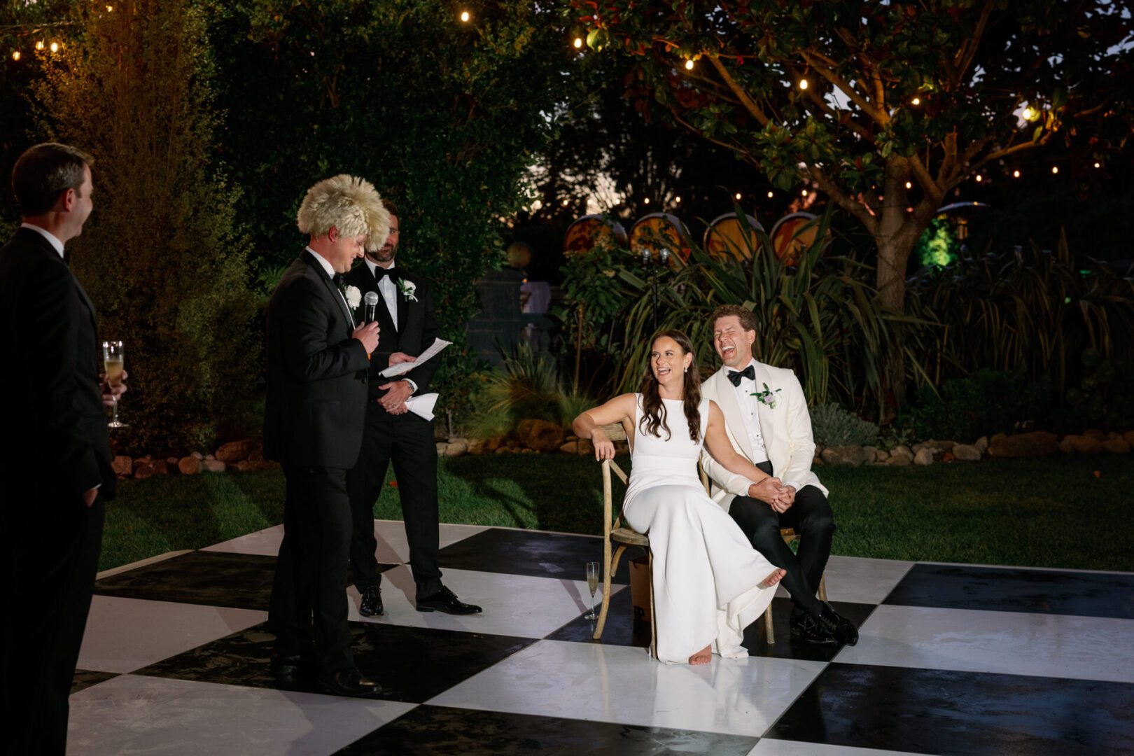 Bride and groom on checkered dance floor.