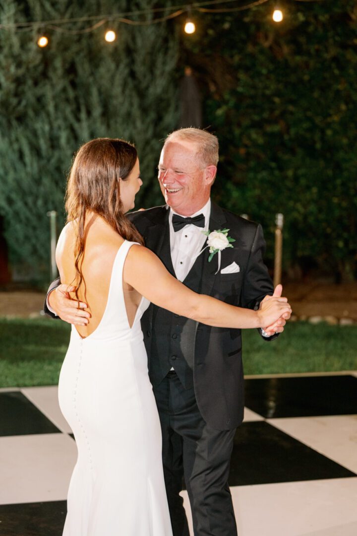 Father and bride dancing at wedding reception.