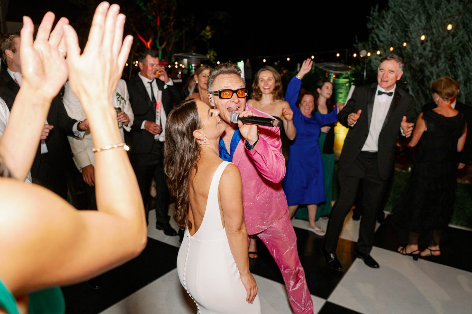 People dancing and singing at a party.